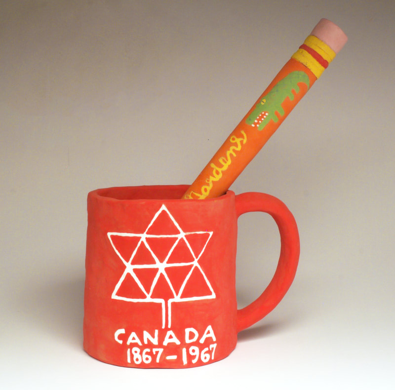 oversized clay souvenir mug and pencil 