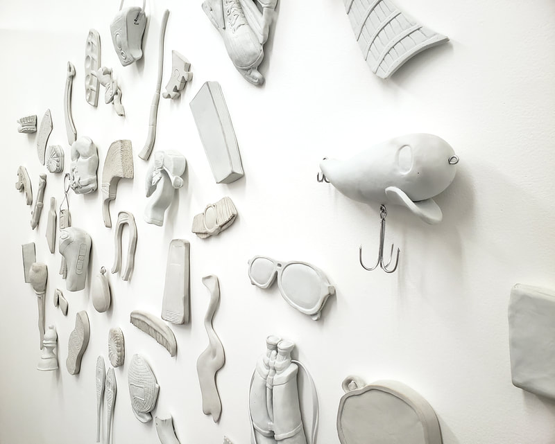 distorted porcelain objects on a white wall