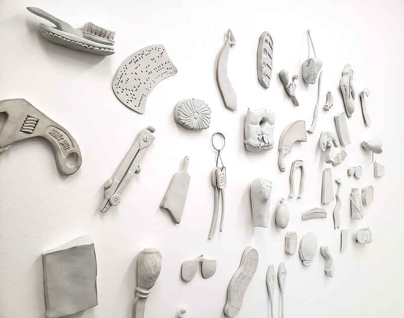 distorted porcelain objects on a white wall