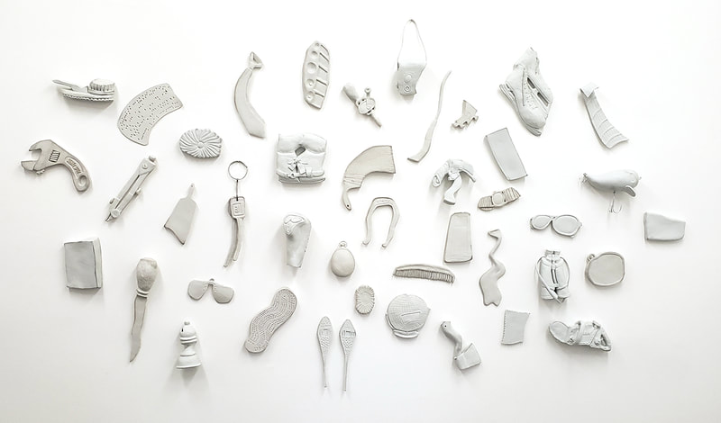 distorted porcelain objects on a white wal